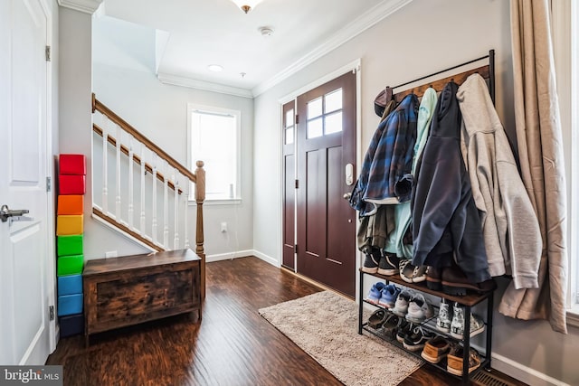 entryway with ornamental molding, stairway, baseboards, and wood finished floors