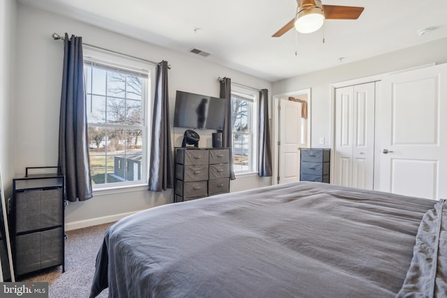 carpeted bedroom featuring a ceiling fan, baseboards, visible vents, and a closet