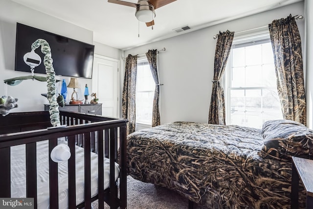 bedroom featuring visible vents and a ceiling fan