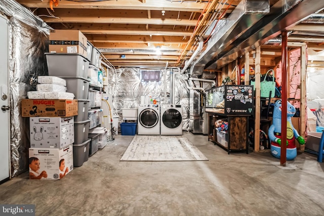 unfinished below grade area featuring independent washer and dryer