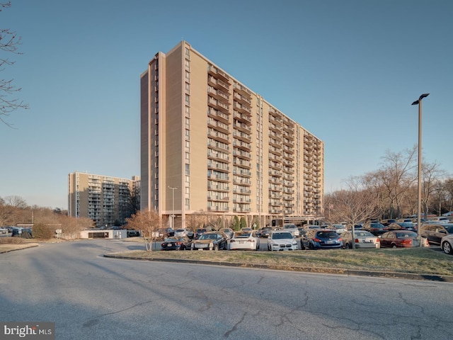 view of building exterior with uncovered parking