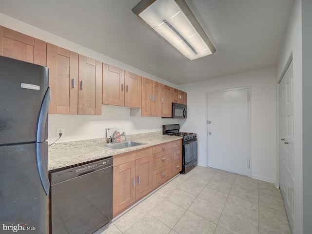 kitchen featuring black appliances, light tile patterned floors, light countertops, and a sink