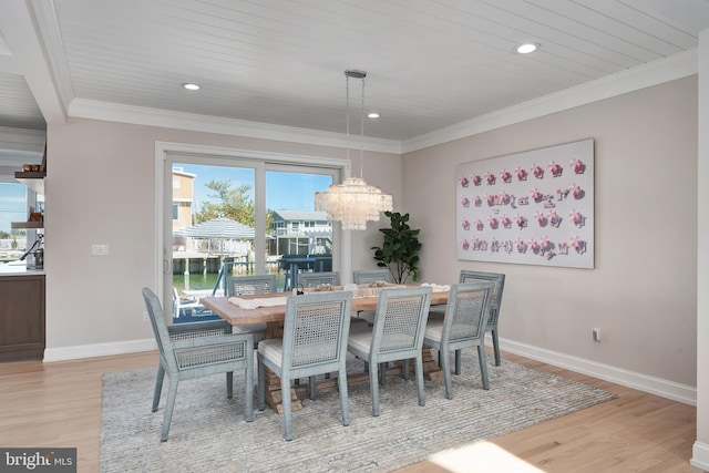 dining area with recessed lighting, crown molding, wood finished floors, baseboards, and an inviting chandelier