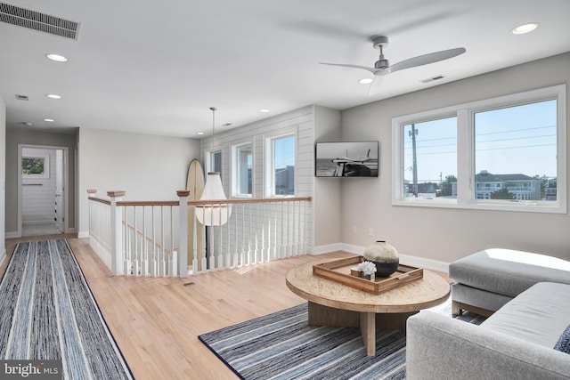 interior space with baseboards, visible vents, wood finished floors, and recessed lighting