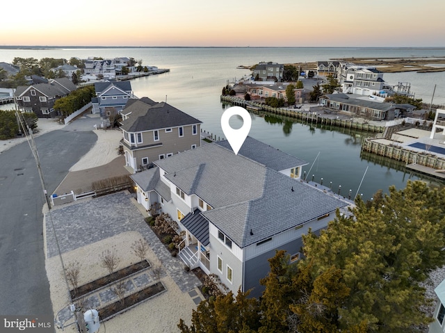 bird's eye view with a residential view and a water view