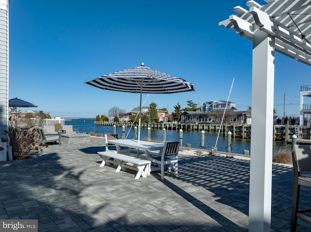 view of patio / terrace with a water view and outdoor dining space