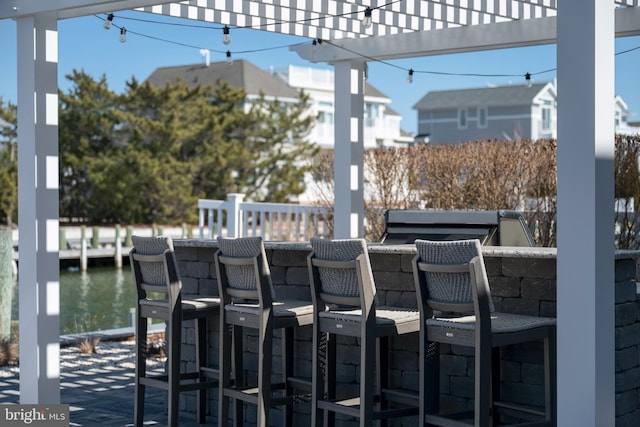 view of patio featuring outdoor dry bar and a pergola