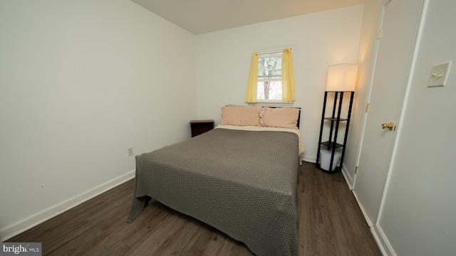 bedroom featuring wood finished floors and baseboards