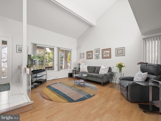 living room featuring high vaulted ceiling, beamed ceiling, and wood finished floors