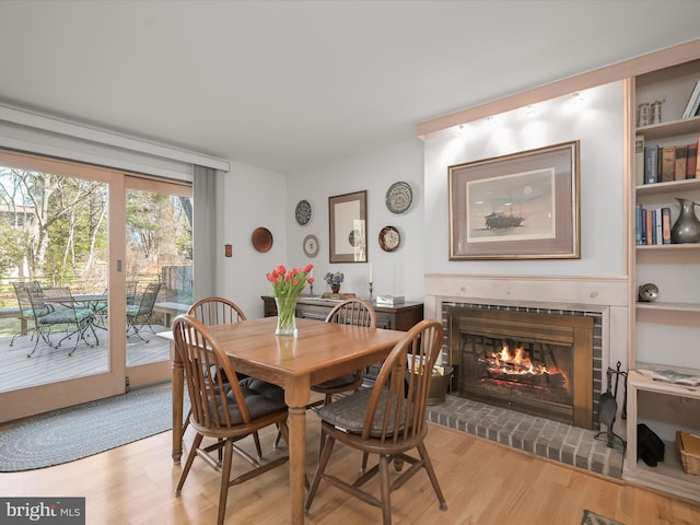 dining room with a fireplace and wood finished floors