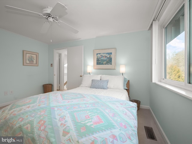 bedroom with ceiling fan, carpet flooring, visible vents, and baseboards