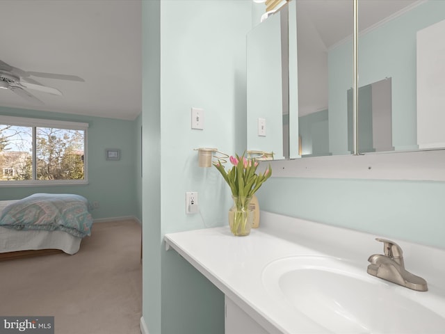 bathroom with baseboards, vanity, a ceiling fan, and crown molding