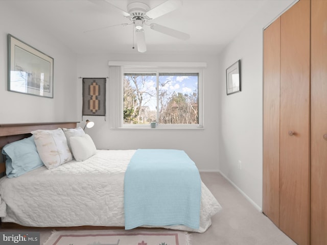 bedroom featuring carpet floors, a closet, baseboards, and a ceiling fan