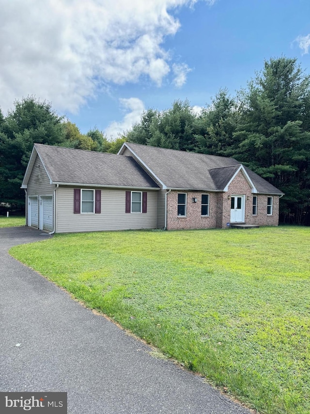 single story home with brick siding, roof with shingles, and a front yard