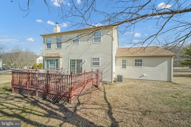 back of house featuring cooling unit, a yard, a chimney, and a wooden deck