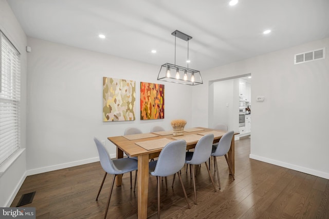 dining area featuring baseboards, visible vents, and dark wood-type flooring