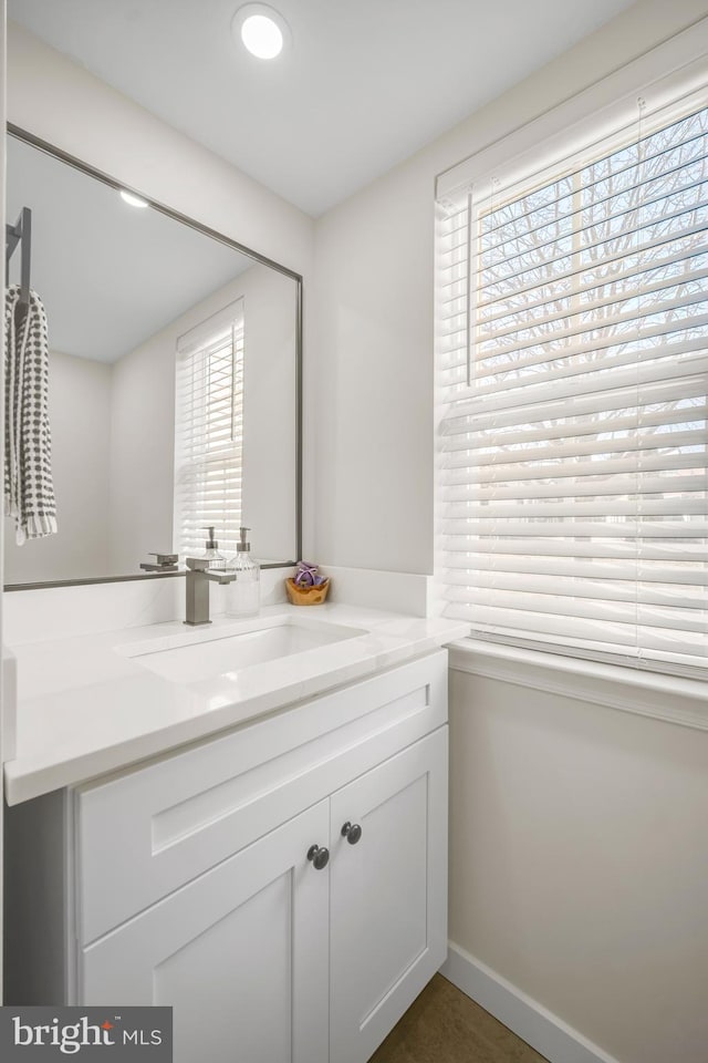 bathroom with vanity and baseboards