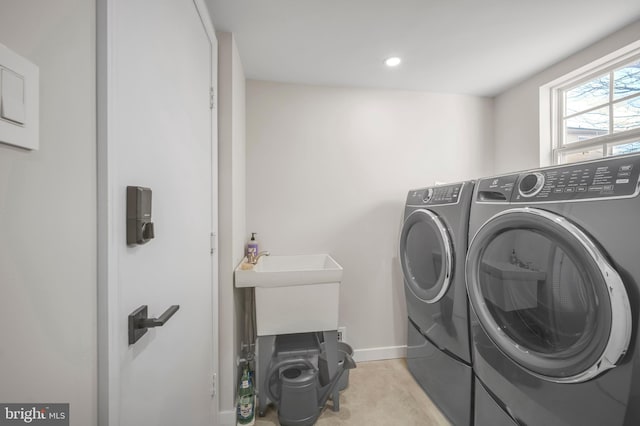 clothes washing area with washer and dryer, laundry area, baseboards, and recessed lighting