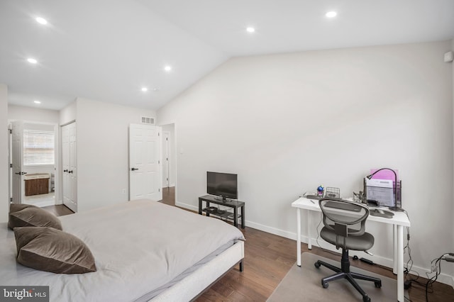 bedroom featuring baseboards, connected bathroom, lofted ceiling, wood finished floors, and recessed lighting