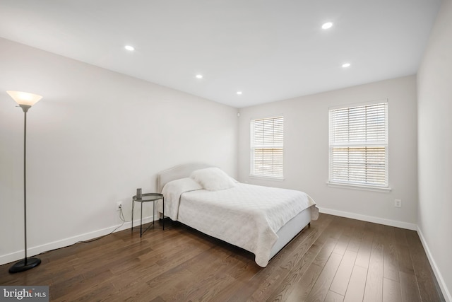 bedroom featuring dark wood-type flooring, recessed lighting, and baseboards