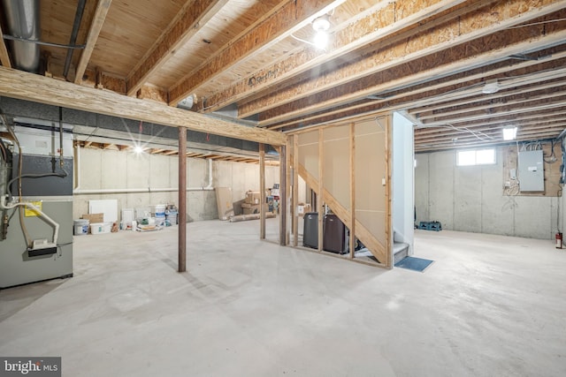 basement with electric panel and heating unit