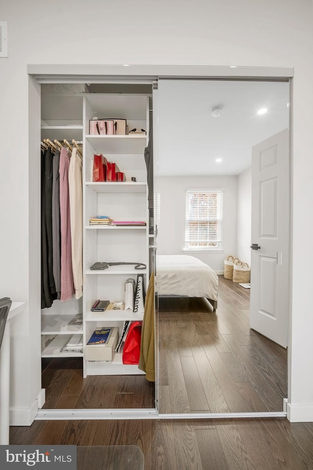 bedroom with recessed lighting, wood finished floors, and baseboards