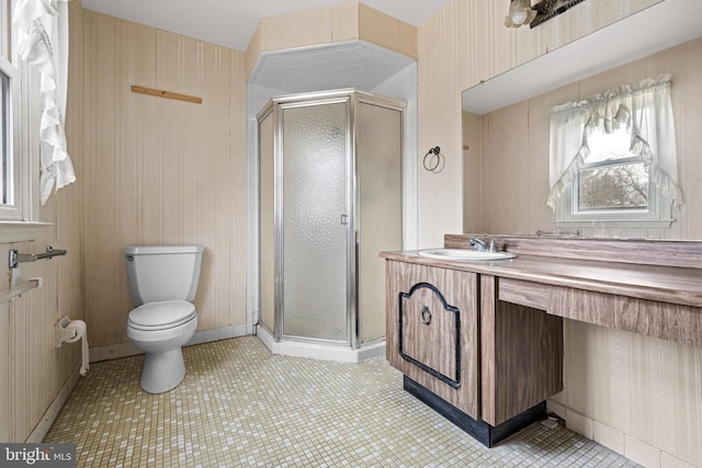 full bath with a stall shower, tile patterned flooring, vanity, and toilet