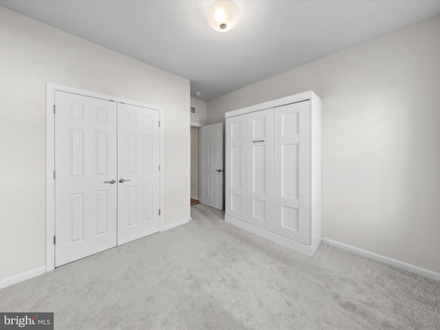 unfurnished bedroom with carpet floors and baseboards