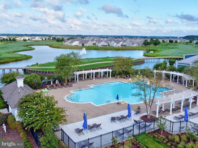 community pool with a water view, fence, a patio, and a pergola