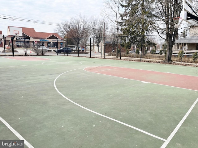 view of basketball court featuring community basketball court and fence