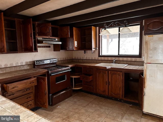 kitchen with tile counters, electric stove, freestanding refrigerator, under cabinet range hood, and open shelves