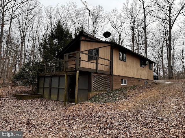 view of home's exterior with a wooden deck