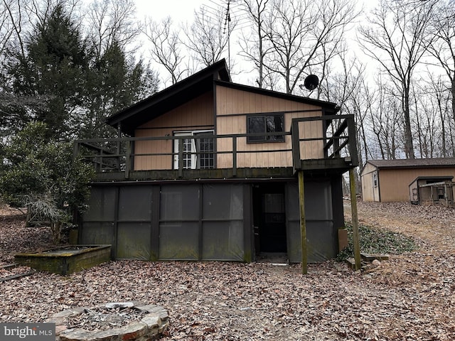 back of property with a wooden deck