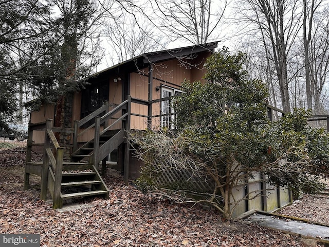 view of side of home featuring stairway