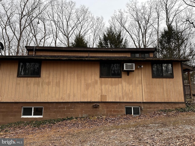 view of home's exterior with a wall mounted air conditioner