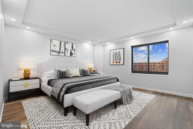 bedroom with recessed lighting, wood-type flooring, and baseboards