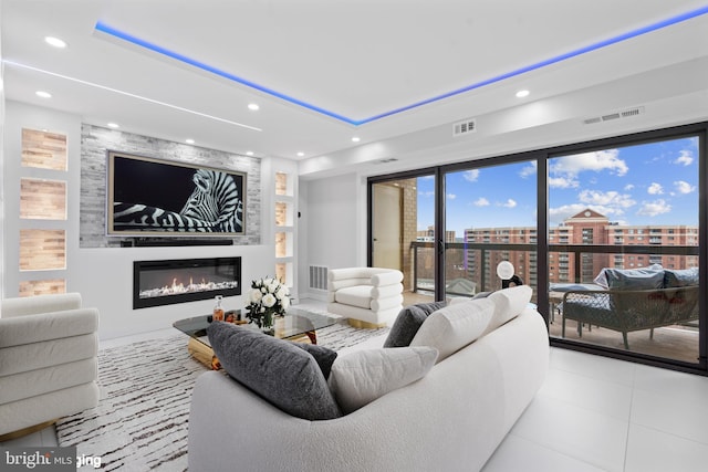 living area featuring a fireplace, visible vents, and recessed lighting