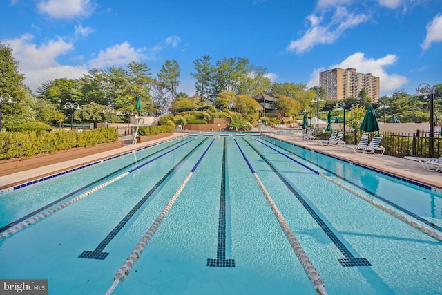 community pool featuring a patio area and fence