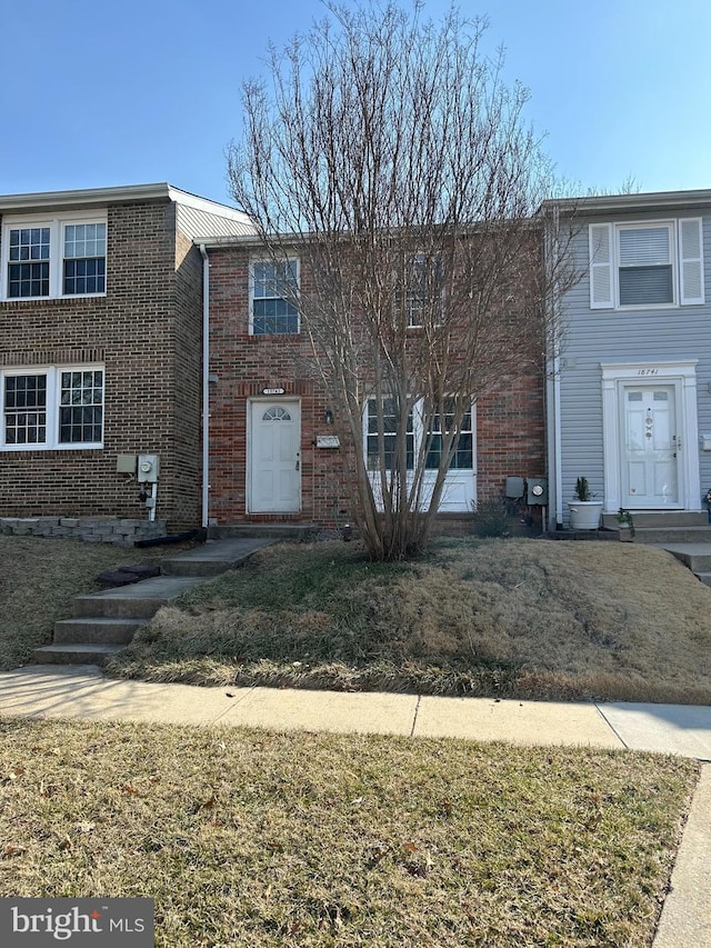 townhome / multi-family property with brick siding