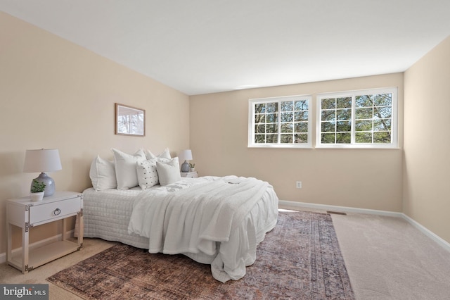 carpeted bedroom with visible vents and baseboards