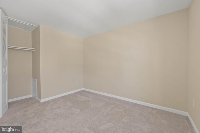 unfurnished bedroom featuring baseboards, carpet floors, and a closet