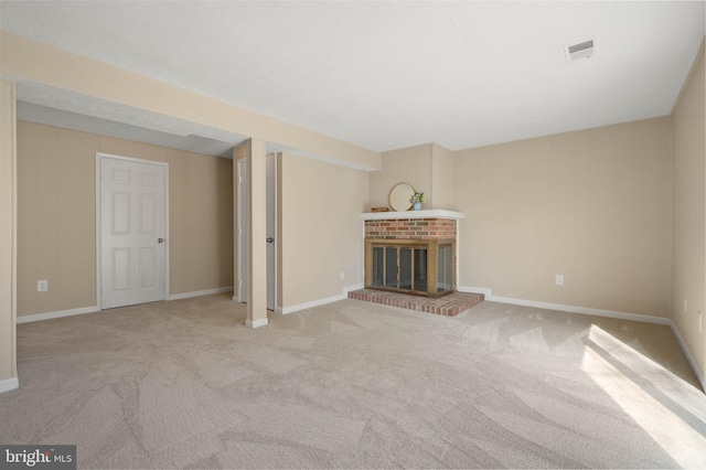 unfurnished living room featuring visible vents, carpet floors, baseboards, and a fireplace