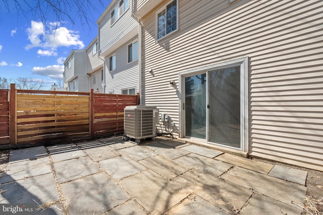 view of patio / terrace featuring central AC and fence