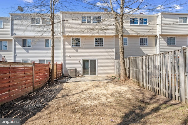 rear view of property with a fenced backyard