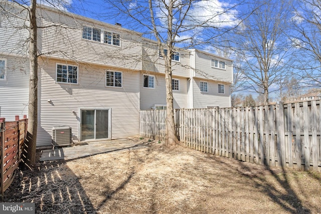 back of property featuring a patio area, central air condition unit, and a fenced backyard