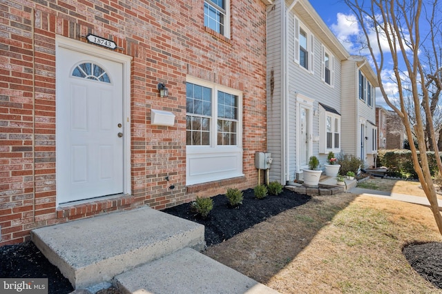 property entrance with brick siding