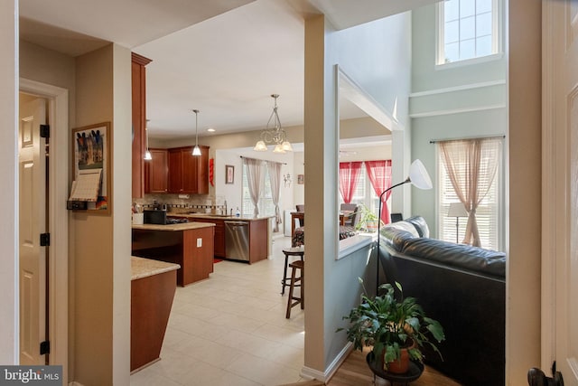 kitchen with dishwasher, open floor plan, a wealth of natural light, and decorative backsplash