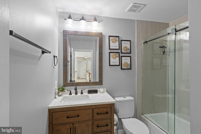 bathroom with toilet, combined bath / shower with glass door, vanity, and visible vents