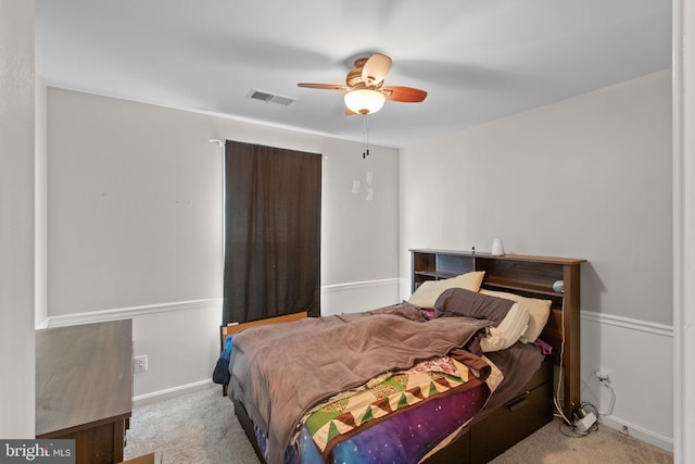 carpeted bedroom with baseboards, visible vents, and a ceiling fan