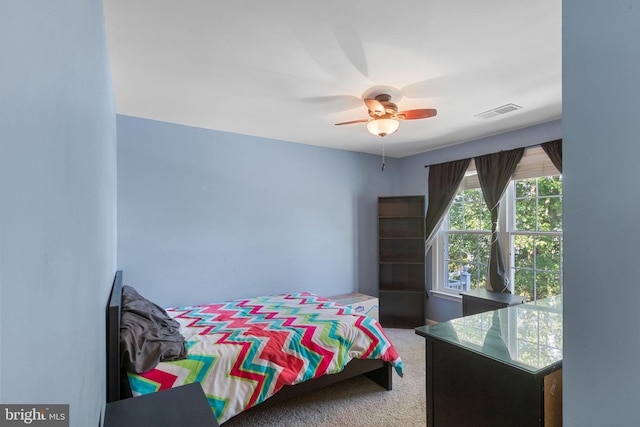 bedroom with carpet, visible vents, and a ceiling fan